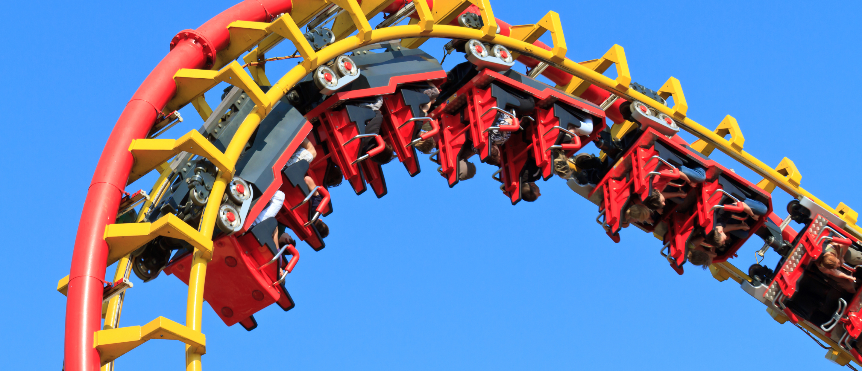 Photograph of people on a loop of a roller coaster