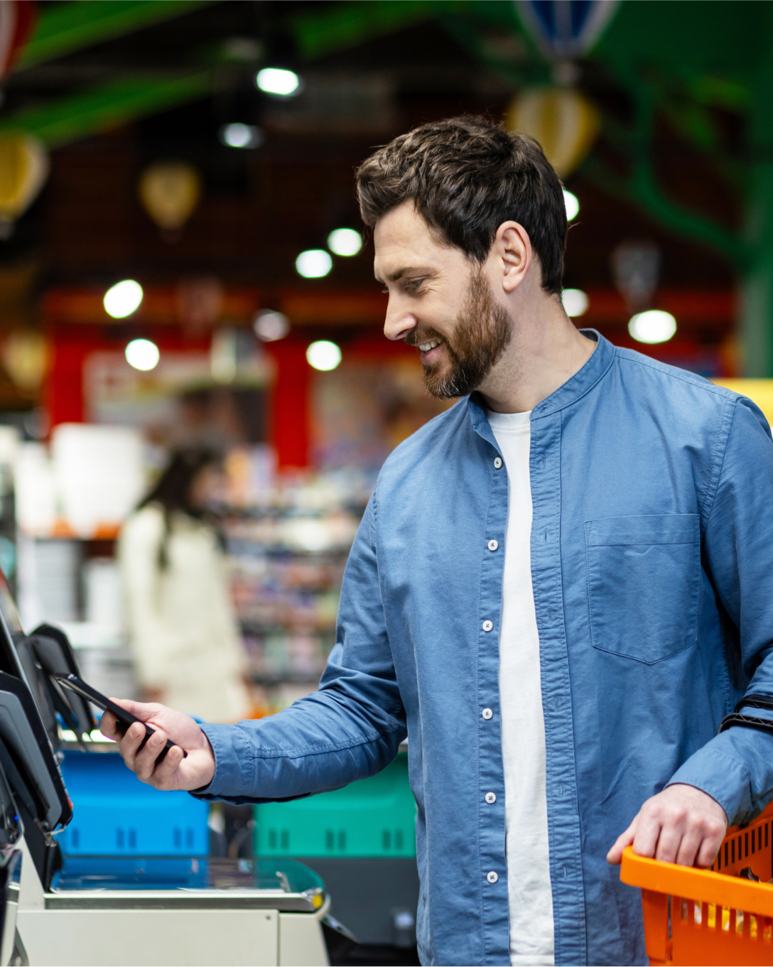 Man using his phone at a self checkout