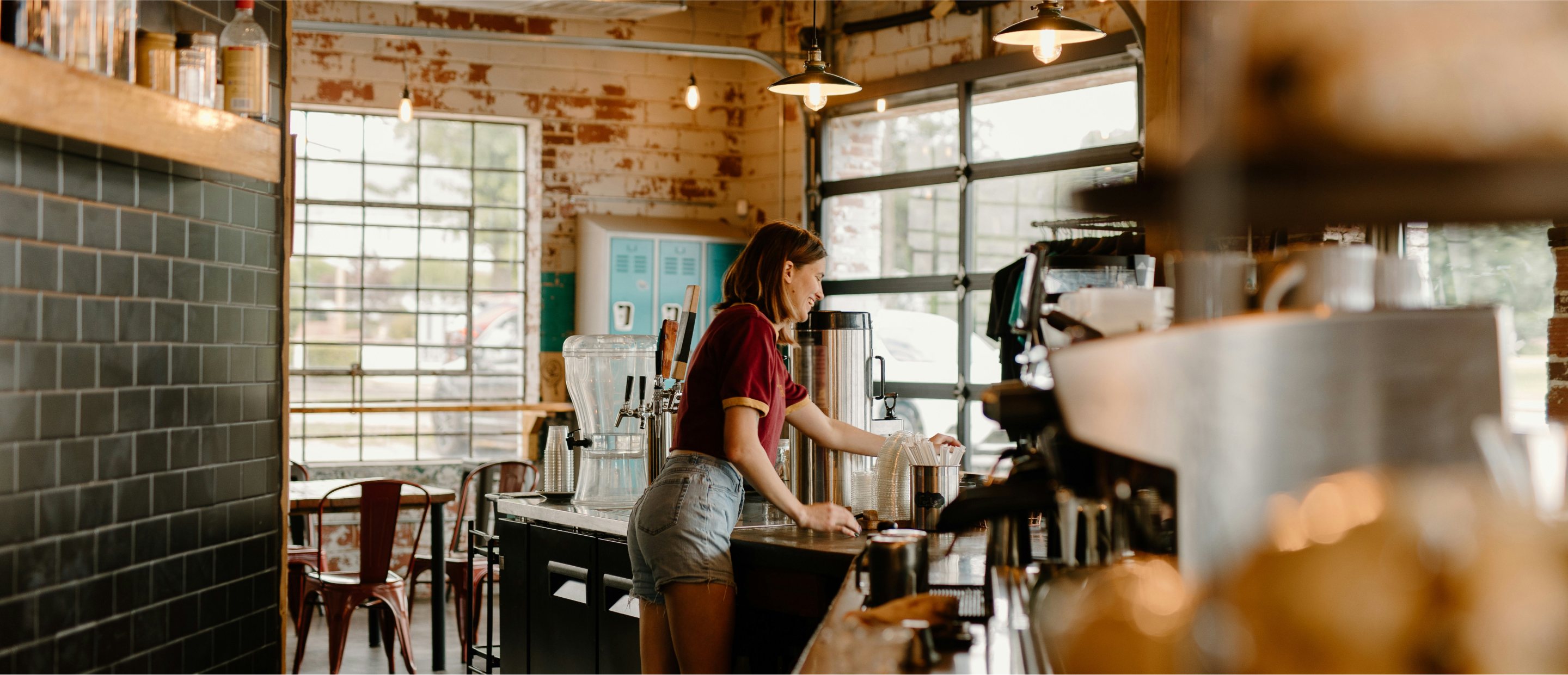 Photograph of a woman behind a coffee counter